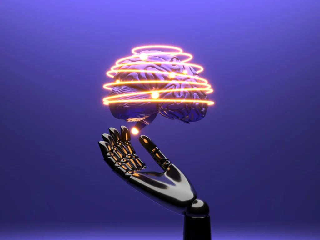 Una mano robótica sosteniendo un cerebro iluminado simboliza la interacción entre la inteligencia artificial (IA) y la cognición humana. En este caso entre los programadores y el primer ingeniero de software IA